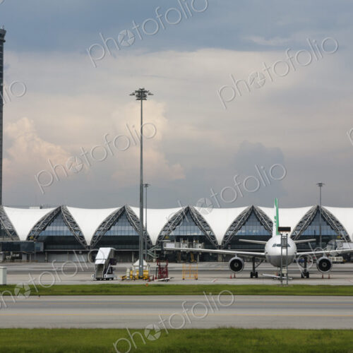 Terminal, control tower and airplane at Bangkok Airport. Terminal, control tower and airplane at Bangkok Airport.