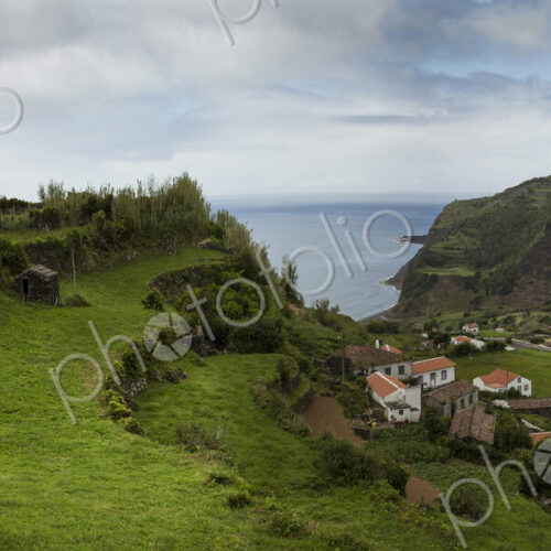 Terraced hillsides over village in coastal landscape
