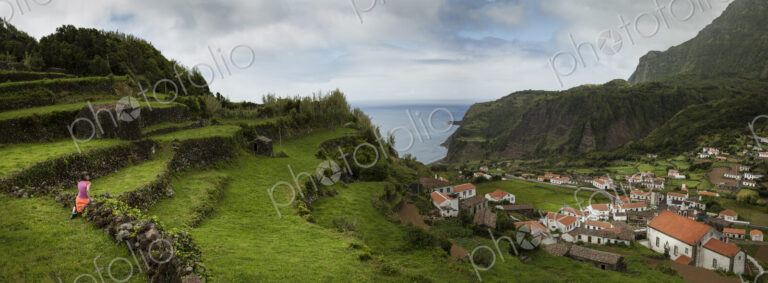 Terraced hillsides over village in coastal landscape