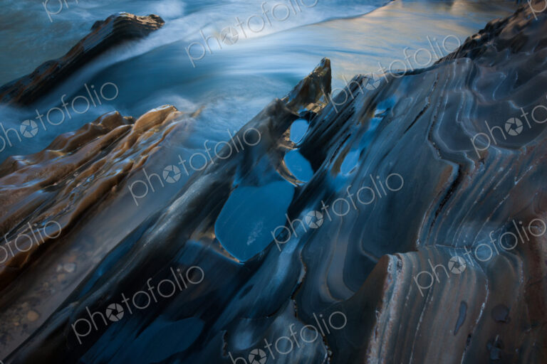 Textured rock at the edge of a stream, Jasper National Park, Alberta, Canada