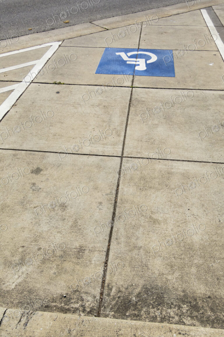 The American blue ADA symbol for wheelchair access or wheelchair use on a path.