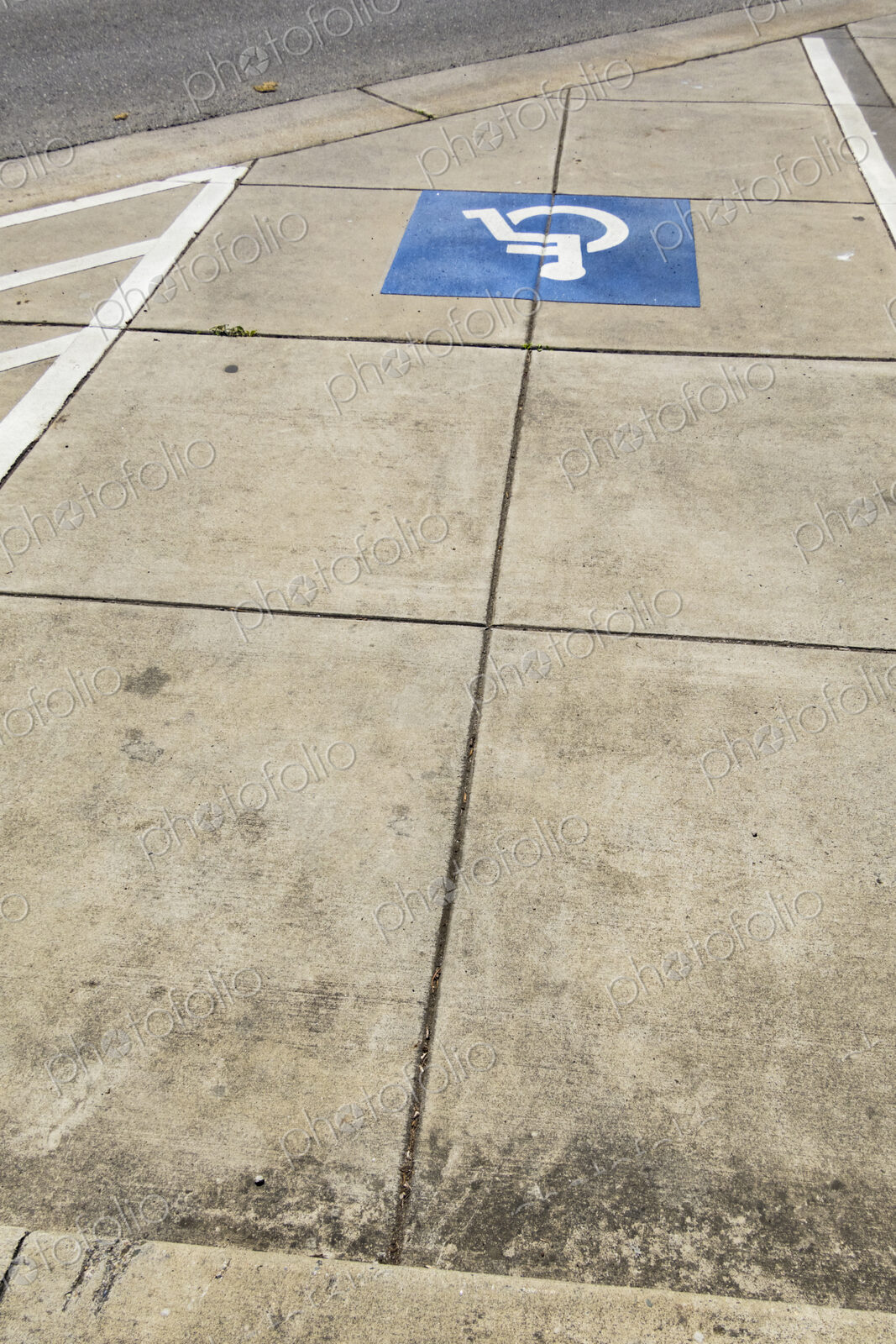 The American blue ADA symbol for wheelchair access or wheelchair use on a path.