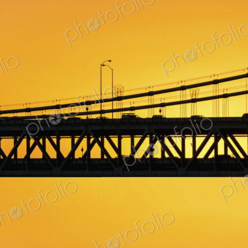 The Bay Bridge silhouetted against a sunset sky The Bay Bridge silhouetted against a sunset sky