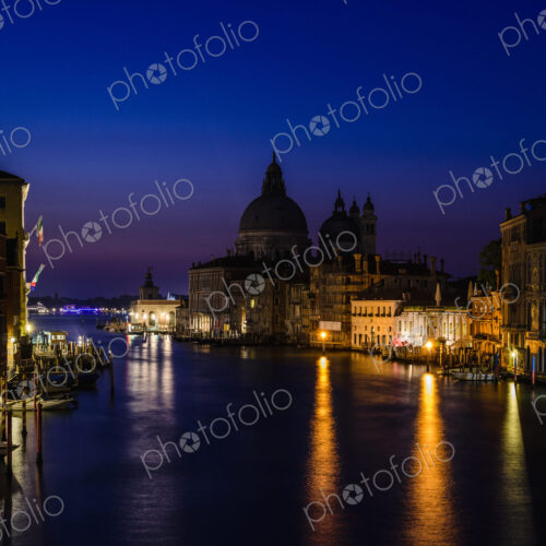 The Grand Canal in Venice, at night, historic buildings in silhouette. The Grand Canal in Venice, at night, historic buildings in silhouette.