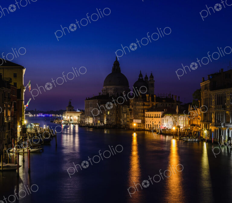 The Grand Canal in Venice, at night, historic buildings in silhouette.