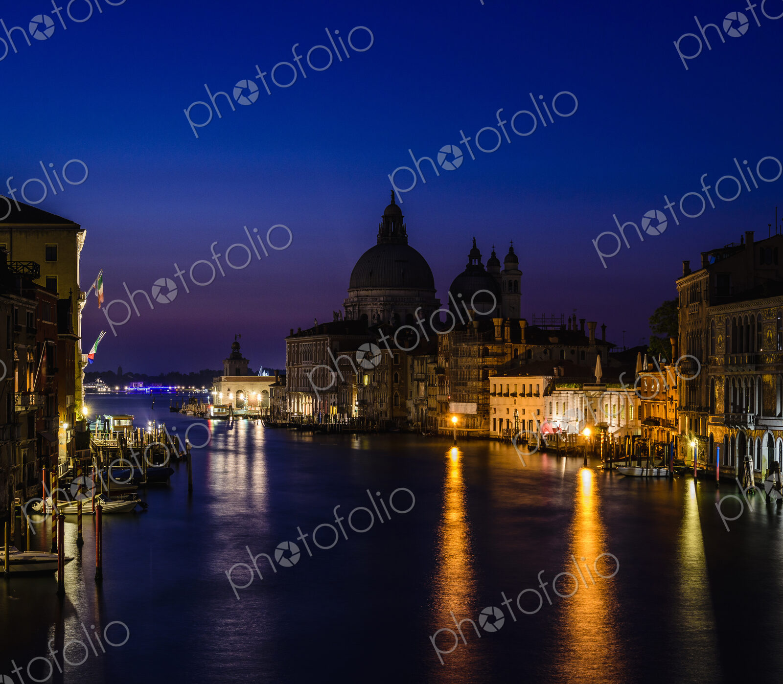 The Grand Canal in Venice, at night, historic buildings in silhouette.