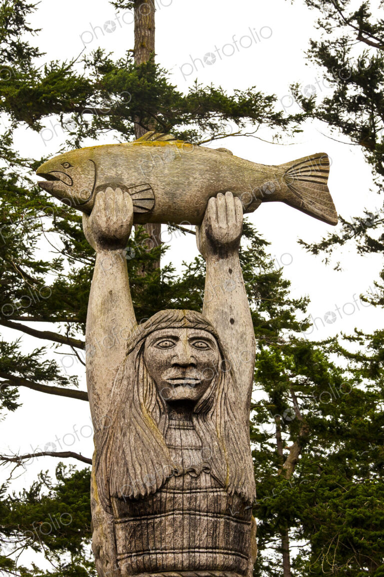 The Maiden of the Pass statue of a Samish Indian Nation fisherman holding a fish above…