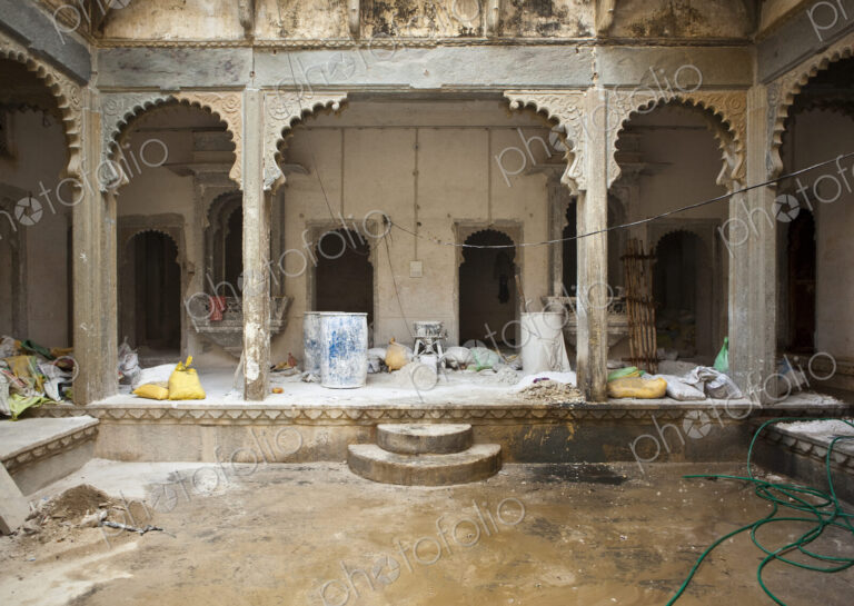 The Monsoon palace in Udaipur, courtyard with a central pool and elegant stone arches,…