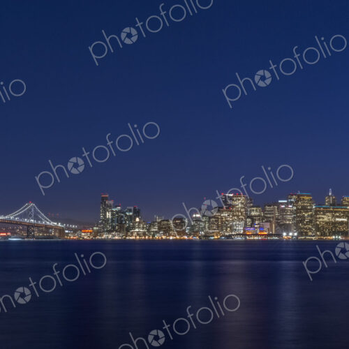 The San Francisco Bay Bridge & Downtown Skyline at Twilight The San Francisco Bay Bridge & Downtown Skyline at Twilight
