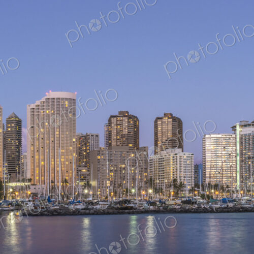 The Waikiki Skyline at dusk, tall buildings, downtown area, waterfront with moorings. The Waikiki Skyline at dusk, tall buildings, downtown area, waterfront with moorings.