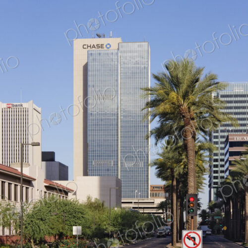 The buildings of downtown Phoenix, skyscrapers and palm trees, roads and stop lights. The buildings of downtown Phoenix, skyscrapers and palm trees, roads and stop lights.