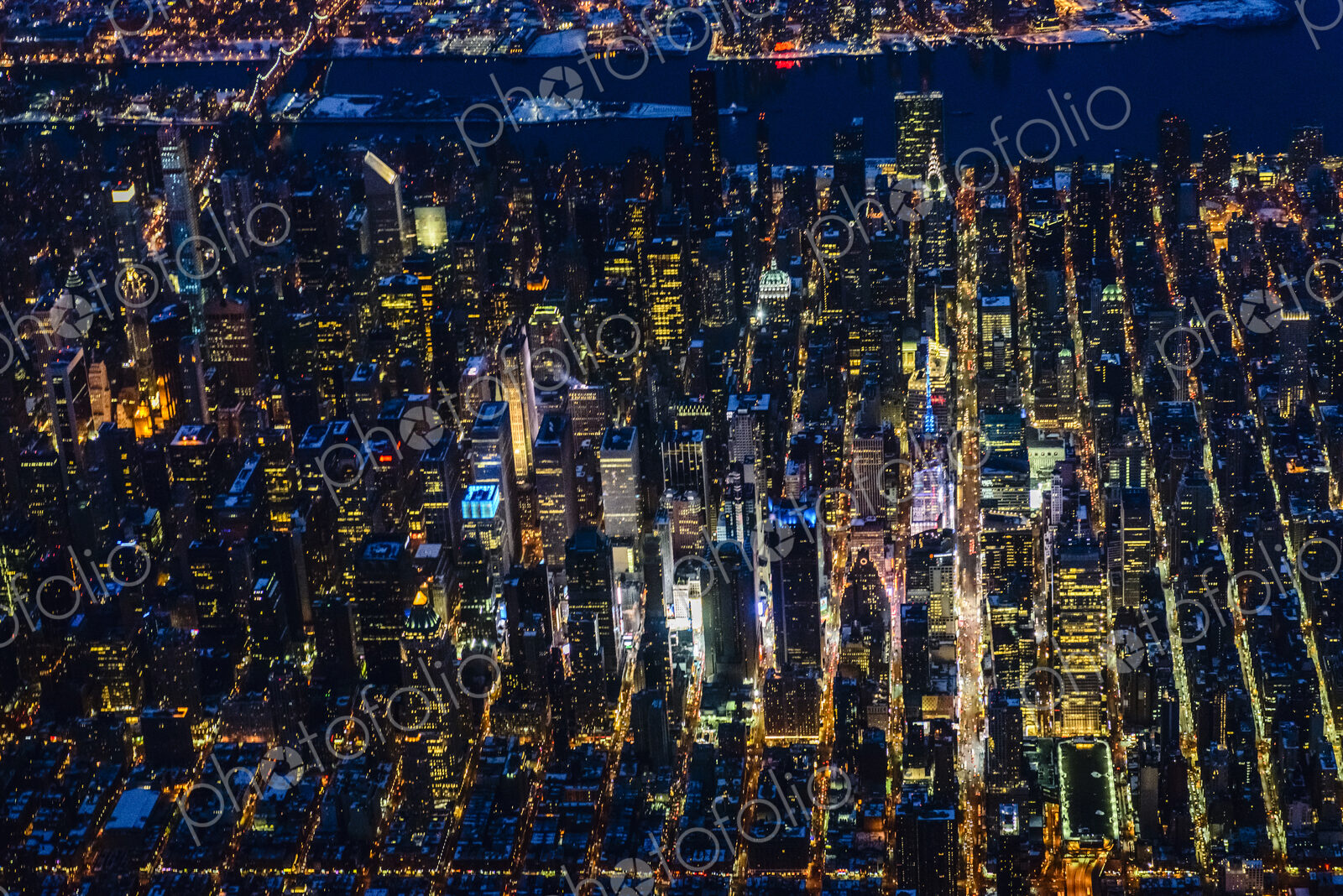 The city of New York City, Manhattan, aerial view at night.