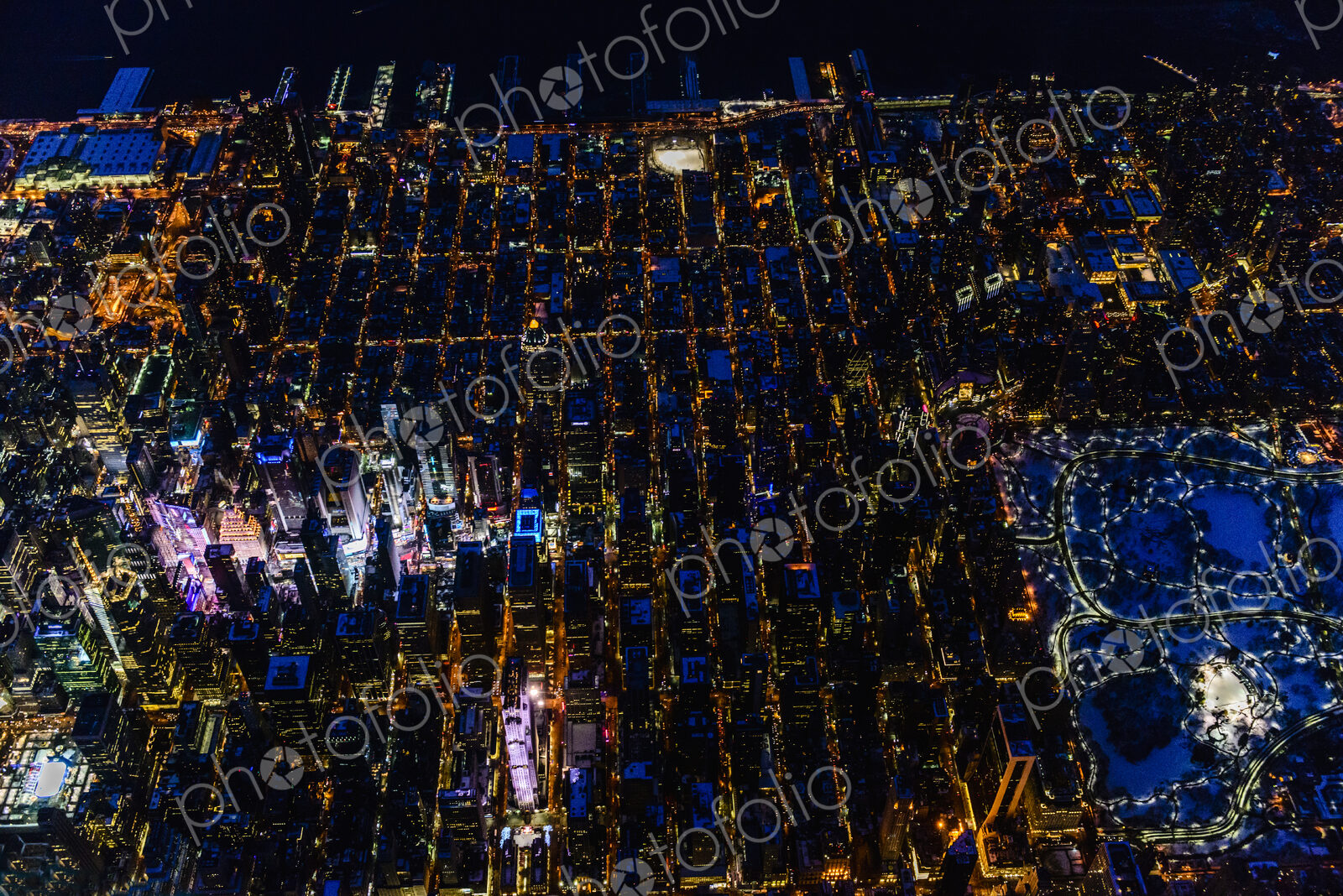The city of New York City, Manhattan, aerial view at night.