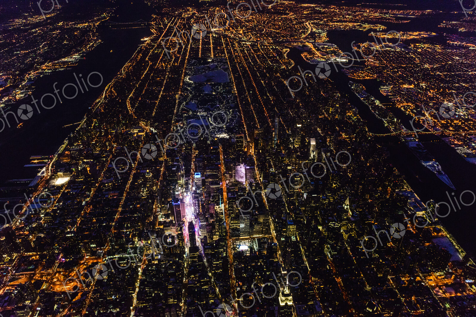 The city of New York City, Manhattan, aerial view at night.