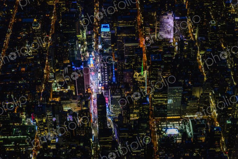 The city of New York City, Manhattan, aerial view at night.