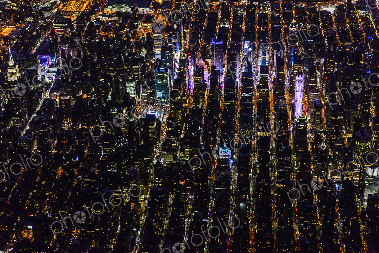 The city of New York City, Manhattan, aerial view at night.