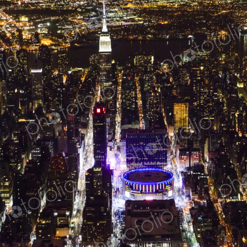 The city of New York City, Manhattan, aerial view at night.