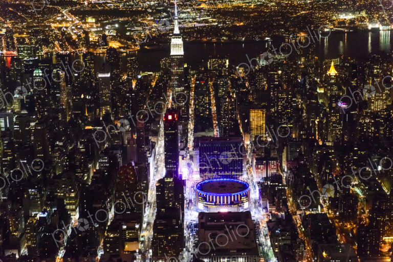 The city of New York City, Manhattan, aerial view at night.