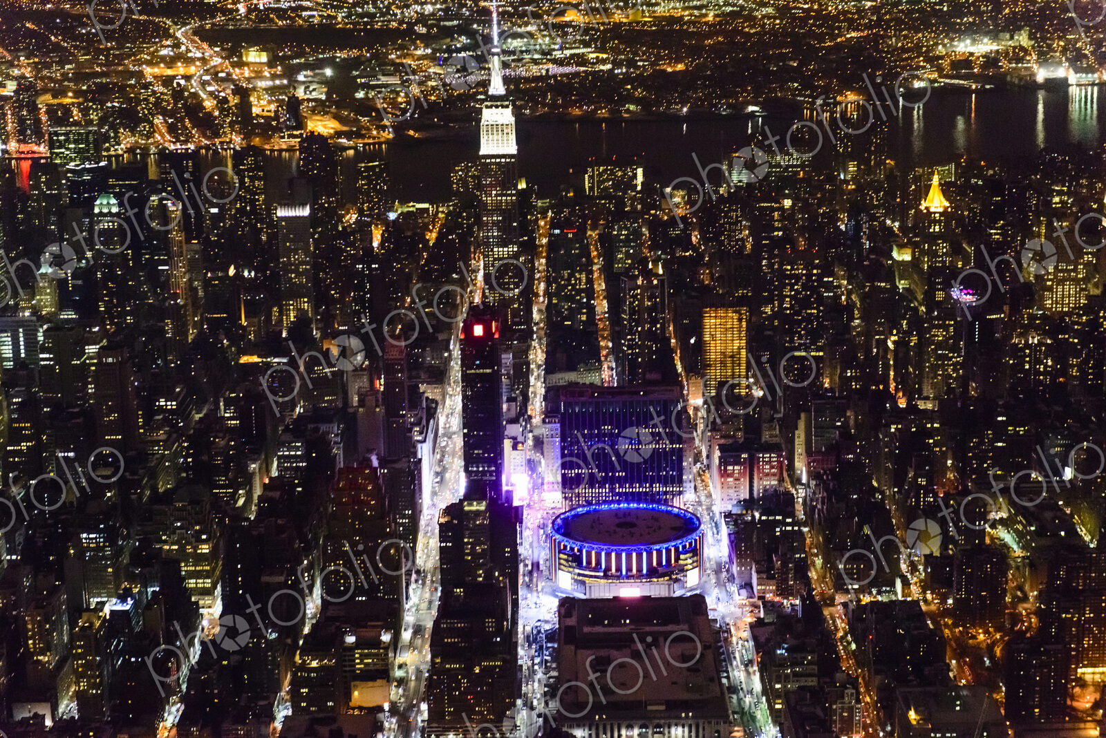 The city of New York City, Manhattan, aerial view at night.