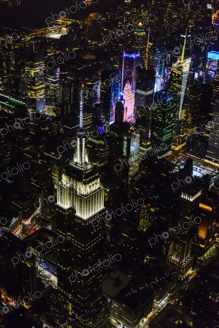 The city of New York City, Manhattan, aerial view at night.