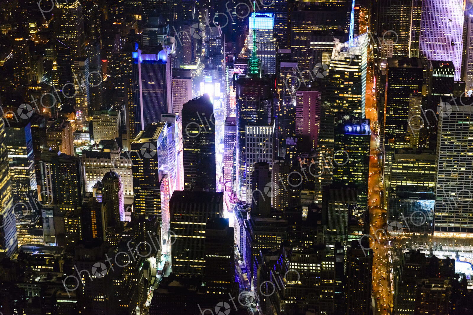 The city of New York City, Manhattan, aerial view at night.