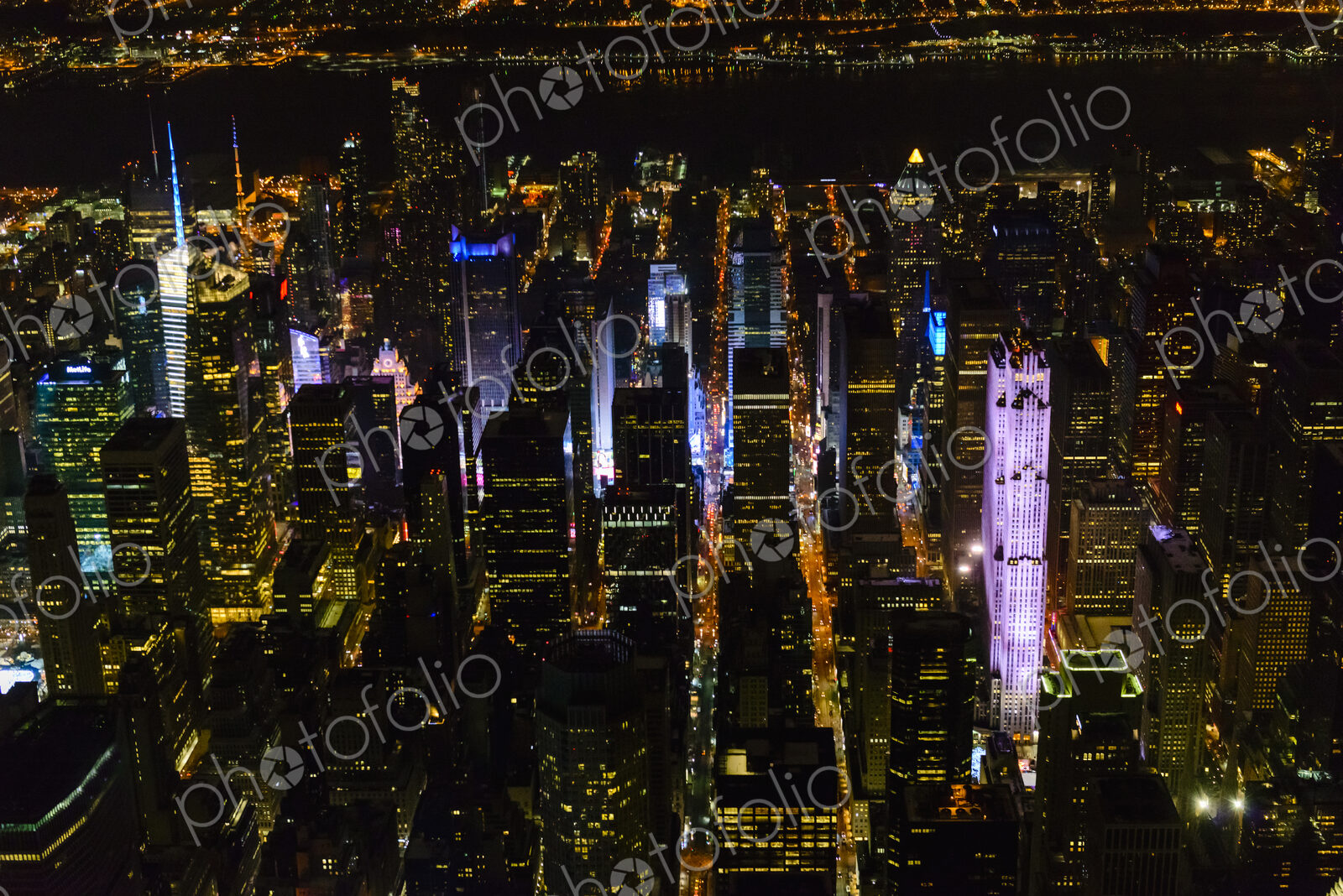The city of New York City, Manhattan, aerial view at night.
