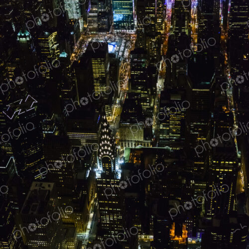 The city of New York City, Manhattan, aerial view at night.