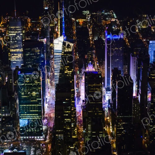 The city of New York City, Manhattan, aerial view at night.