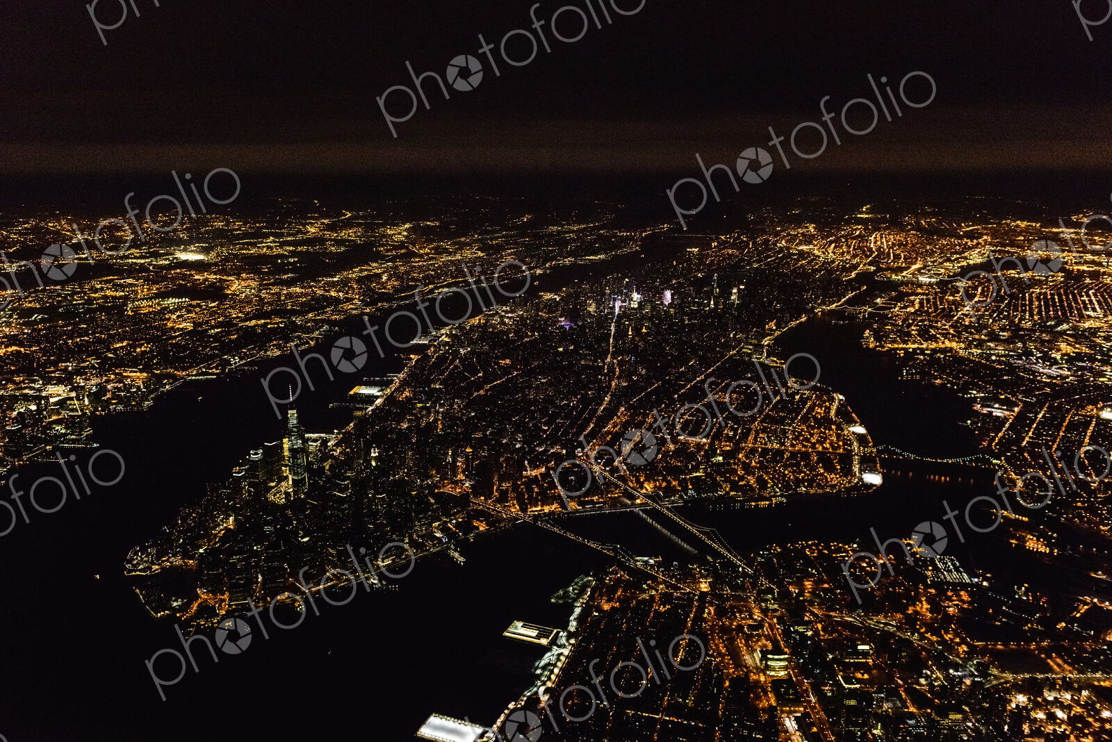 The city of New York City, Manhattan, seen from a high point at night.