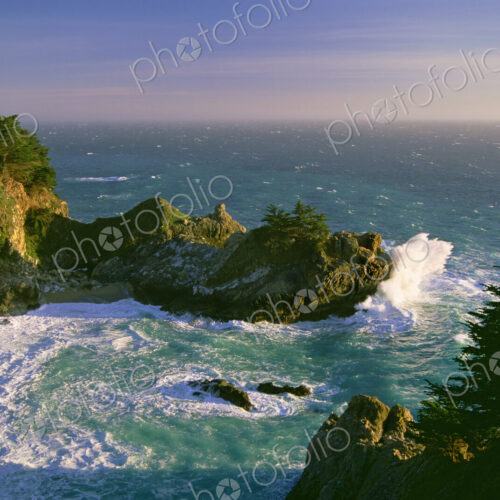 The coastline and a horseshoe bay with waves crashing against the rocks in Julia… The coastline and a horseshoe bay with waves crashing against the rocks in Julia…