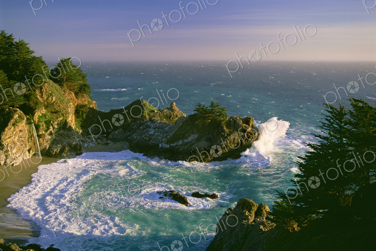 The coastline and a horseshoe bay with waves crashing against the rocks in Julia…