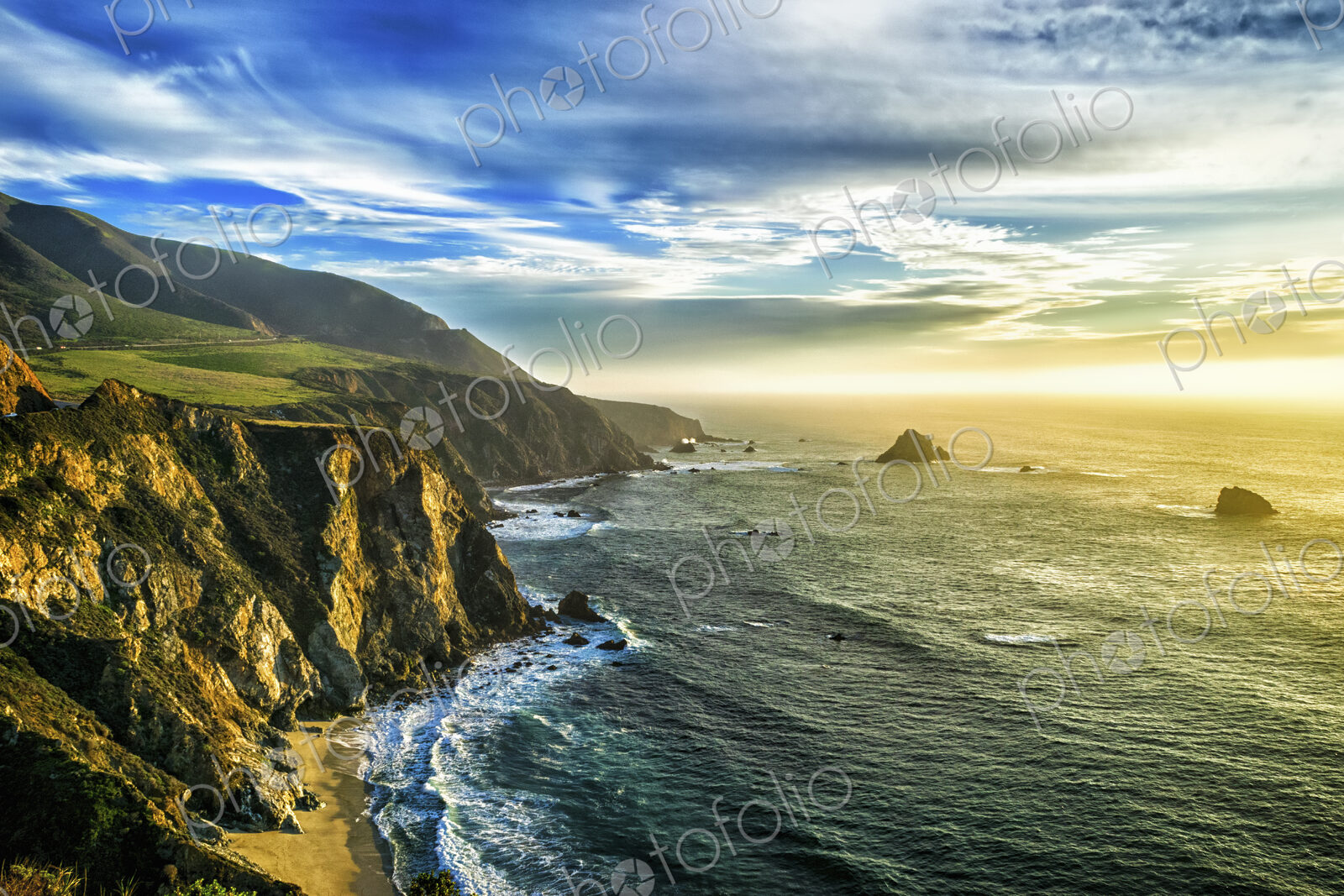 The coastline at Big Sur in california, with steep cliffs and rock stacks in the…