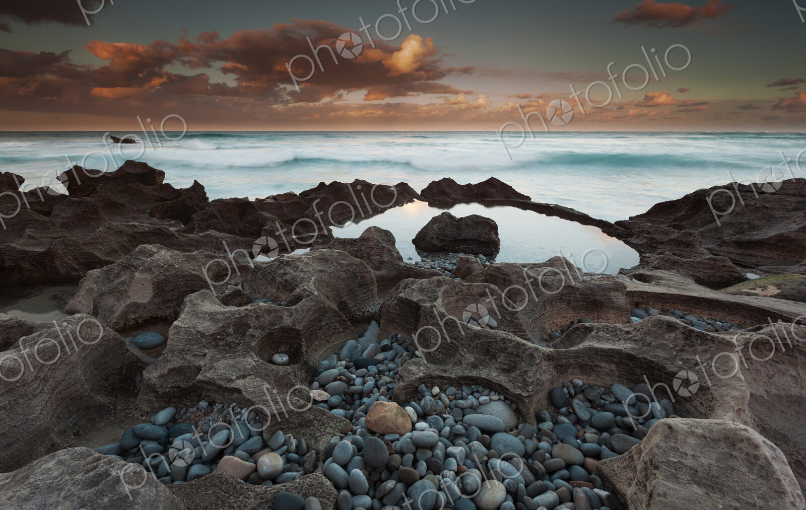 The coastline, bays and cliffs on Cape Agulhas near Arniston at sunset.