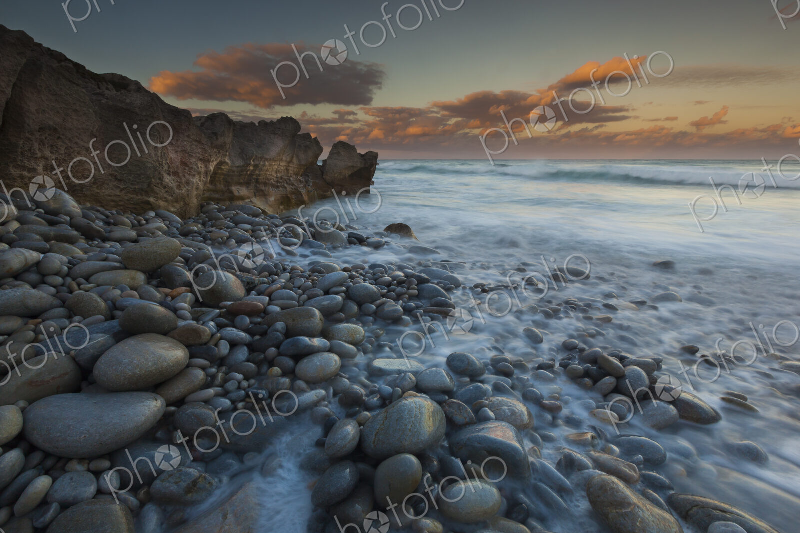 The coastline, bays and cliffs on Cape Agulhas near Arniston at sunset.