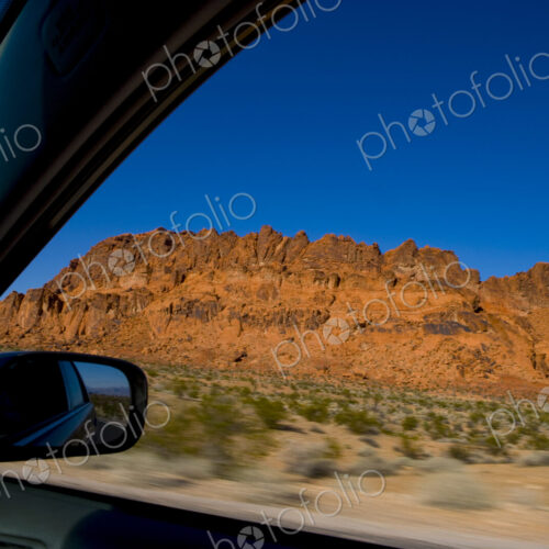 The driver's view of a side mirror, and the open window, a road trip through Red Rock… The driver's view of a side mirror, and the open window, a road trip through Red Rock…