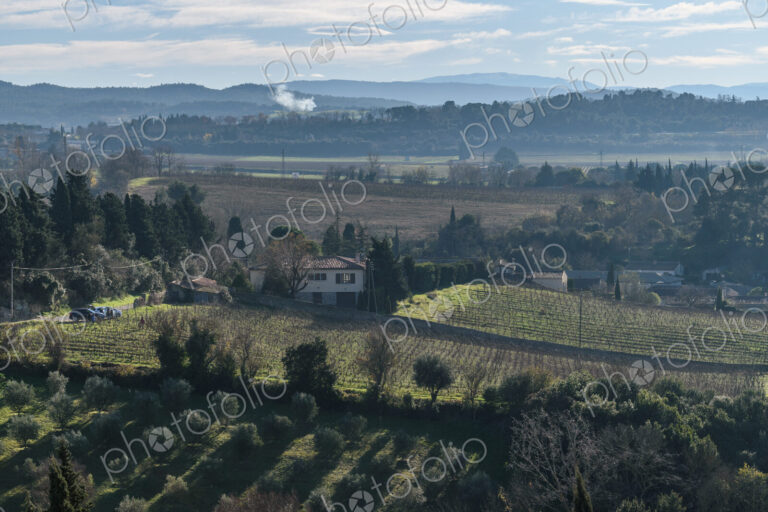 The elevated view over the countryside, fields and farmland and hills in the distance.
