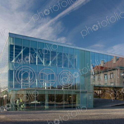 The exterior glass walls of a modern library building, internet icons etched on glass The exterior glass walls of a modern library building, internet icons etched on glass