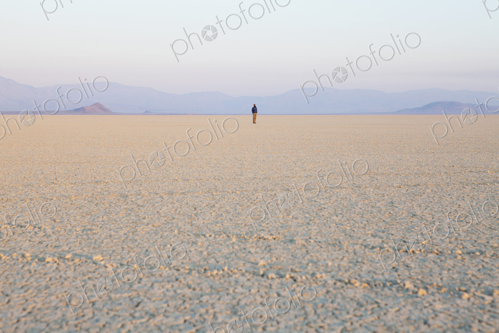 The figure of a man in the empty desert landscape of Black Rock desert, Nevada.