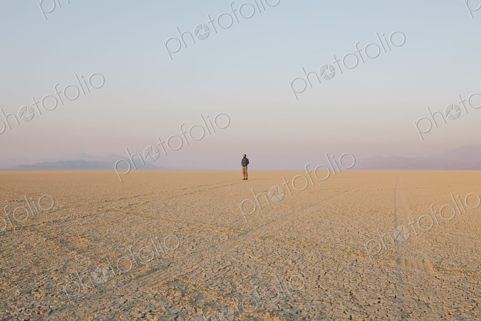 The figure of a man in the empty desert landscape of Black Rock desert, Nevada.