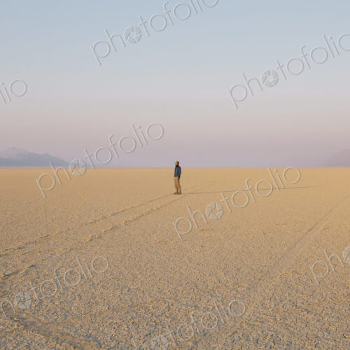 The figure of a man in the empty desert landscape of Black Rock desert, Nevada.