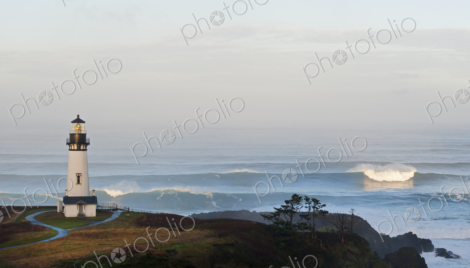 The historic Yaquina Head tower lighthouse on a headland overlooking the Pacific…