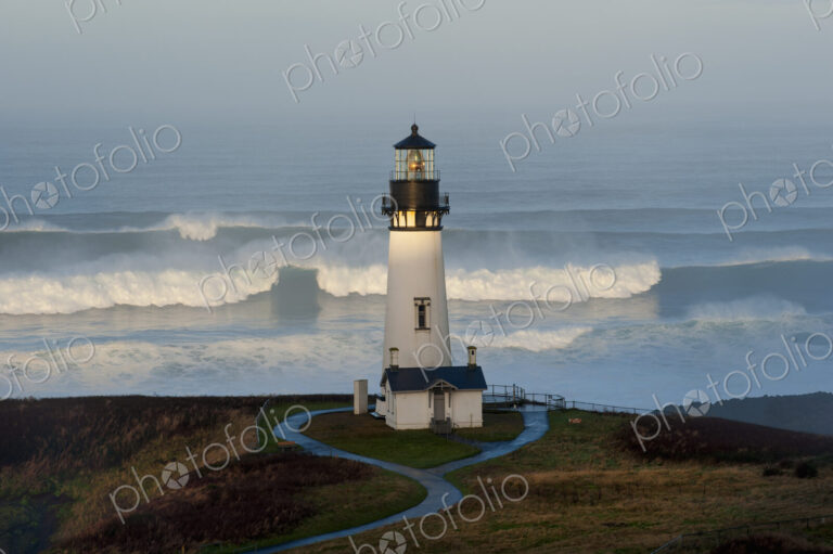 The historic Yaquina Head tower lighthouse on a headland overlooking the Pacific…