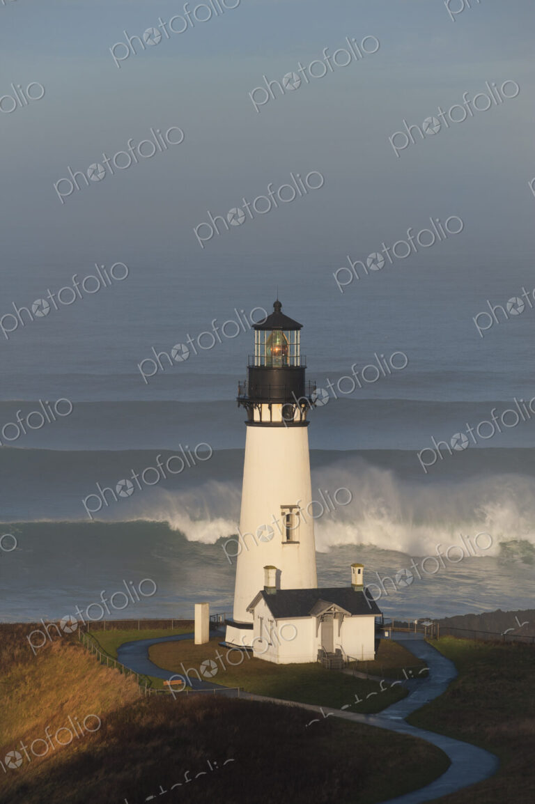 The historic Yaquina Head tower lighthouse on a headland overlooking the Pacific…
