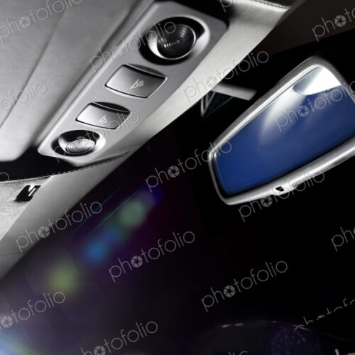 The interior of a luxury sports car at night.
