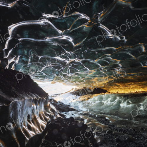 The interior of an ice cave with clear contoured ice on the ceiling, walls of ice and… The interior of an ice cave with clear contoured ice on the ceiling, walls of ice and…