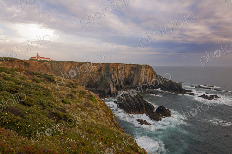 The lighthouse on the headland on the Atlantic coastline.