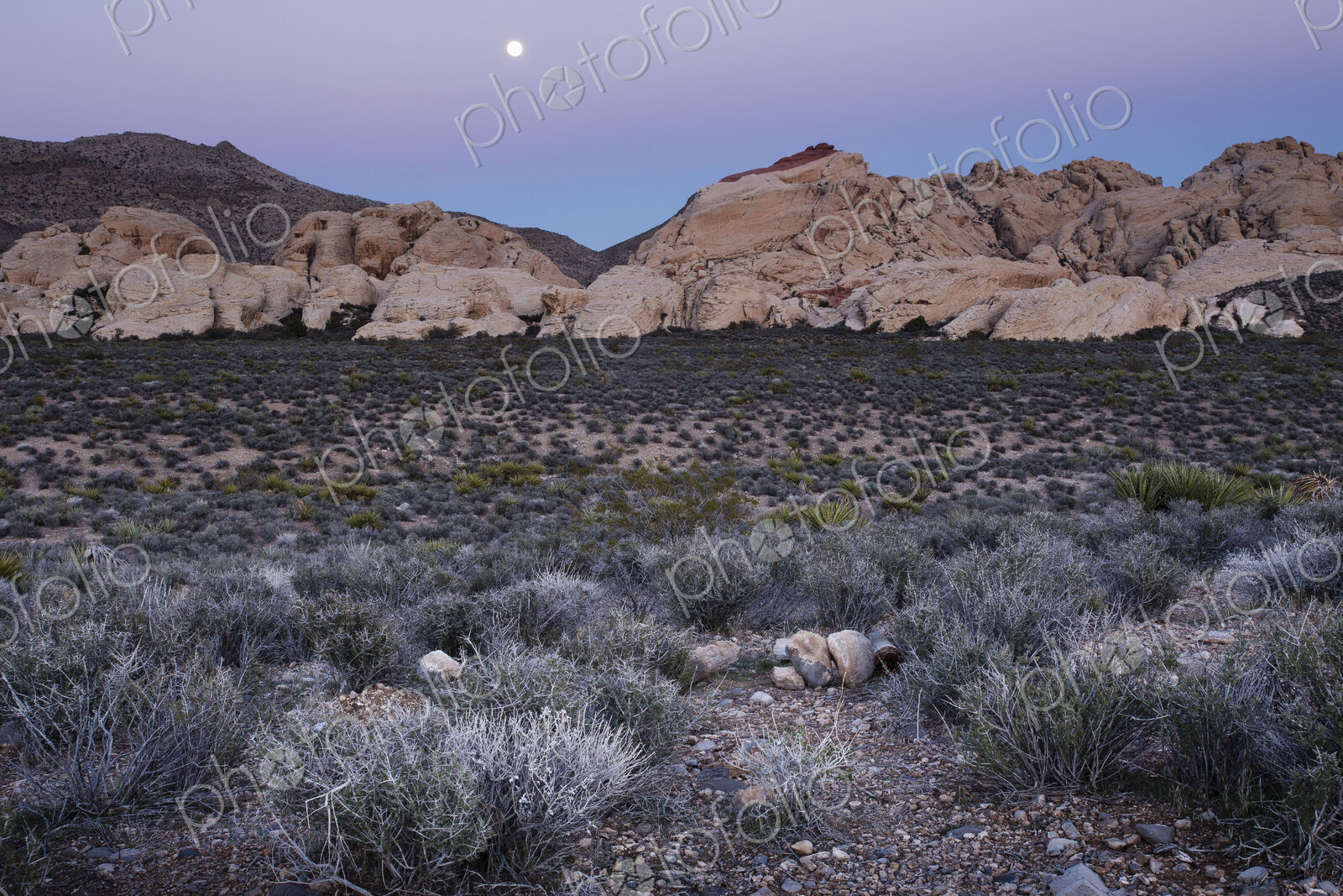 The moon rising over the mountains in Red Rock Canyon in Nevada.