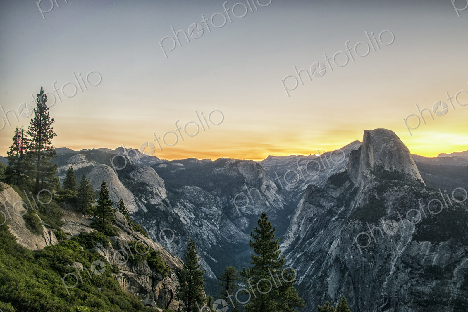 The mountain range in Yosemite valley at sunset, with distinct rock formations and…