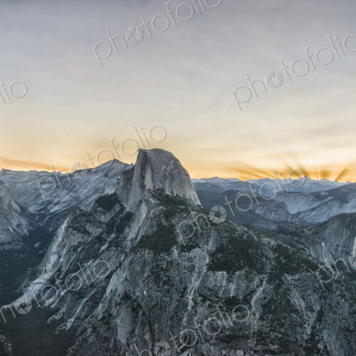 The mountain range in Yosemite valley at sunset. The Half Dome landmark The mountain range in Yosemite valley at sunset. The Half Dome landmark