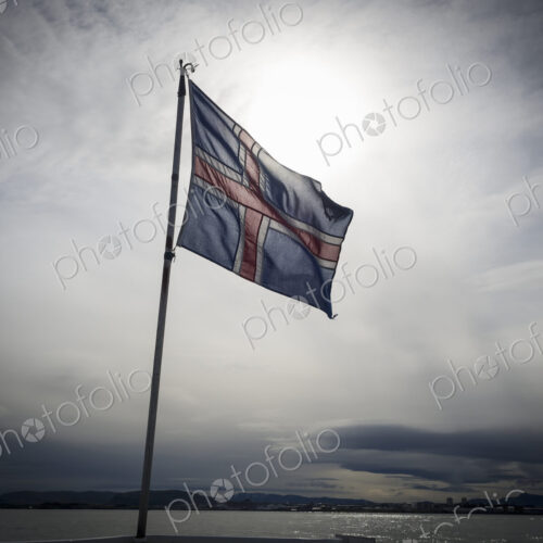 The national flag of Iceland, flying against a cloudy sky The national flag of Iceland, flying against a cloudy sky